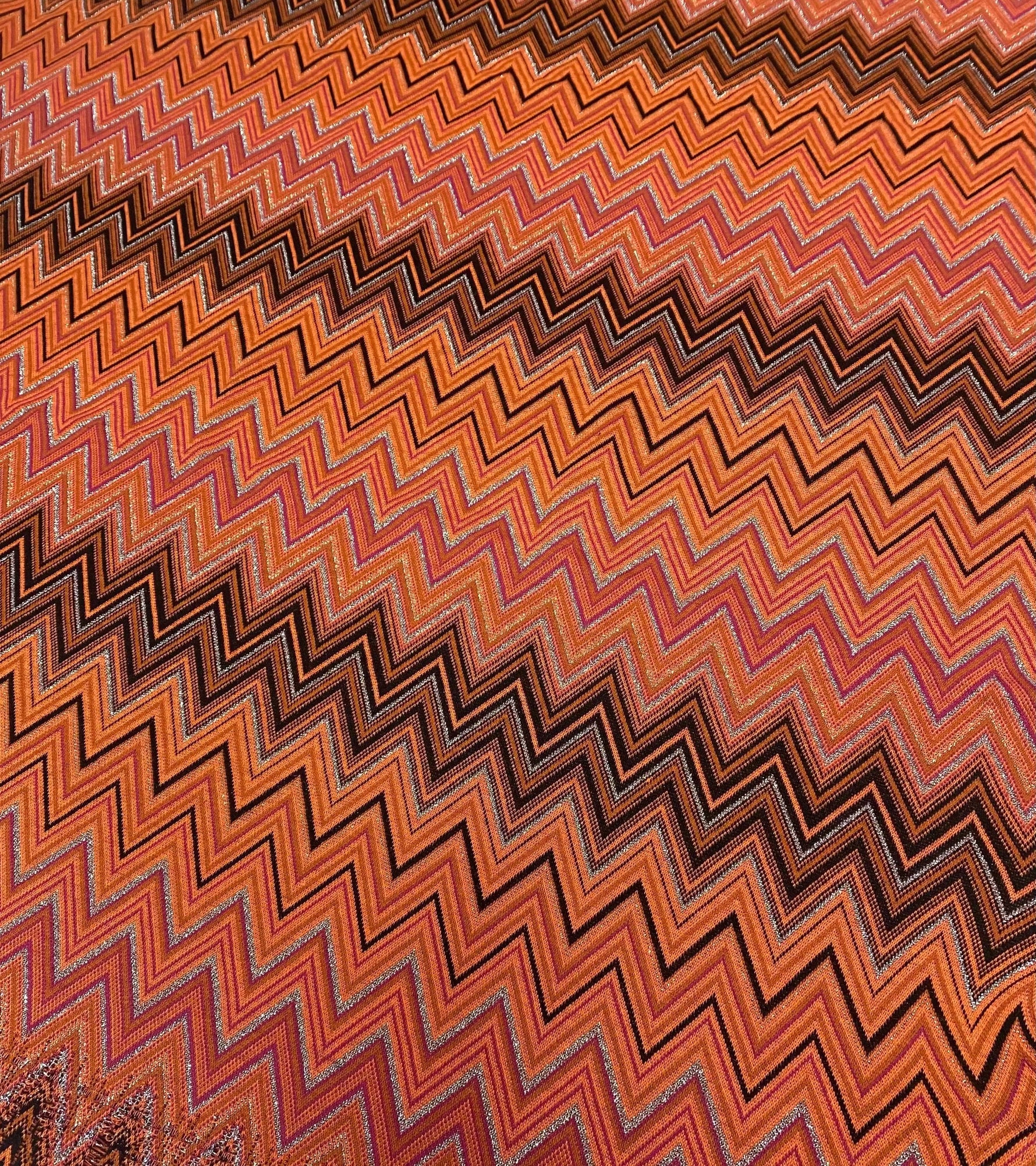 Black-orange glitter mesh knitted fabric with zigzag pattern for crafting and fashion projects