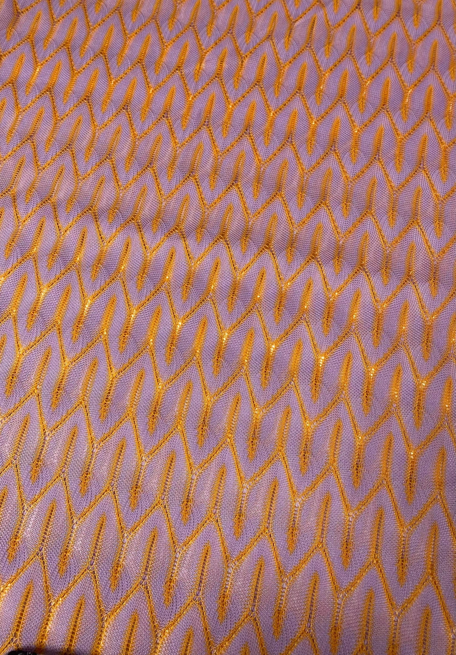 Zigzag knit jersey mesh fabric in lilac with orange zigzag pattern, lightweight and breathable textile for apparel and crafts