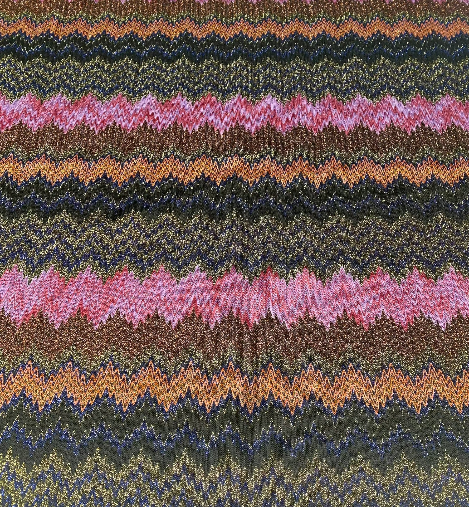 Glittery zigzag mesh knitted fabric with colorful shimmering pattern for crafting and fashion projects