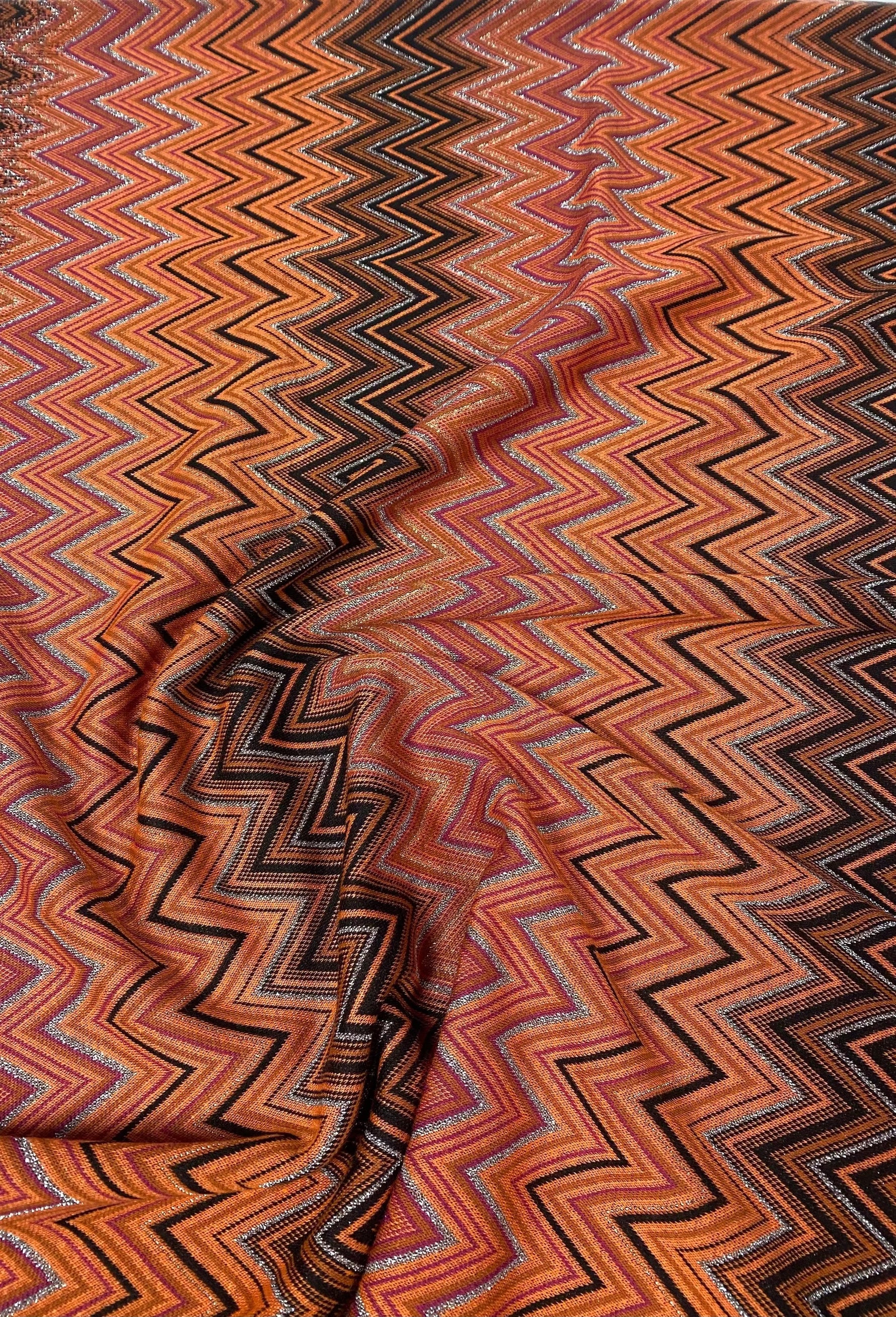Black-orange glitter mesh knitted fabric with zigzag pattern for crafting and fashion projects