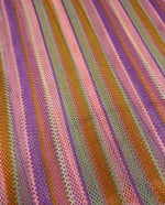 Pink striped knit mesh fabric with breathable texture and colorful vertical stripes for fashion and crafts