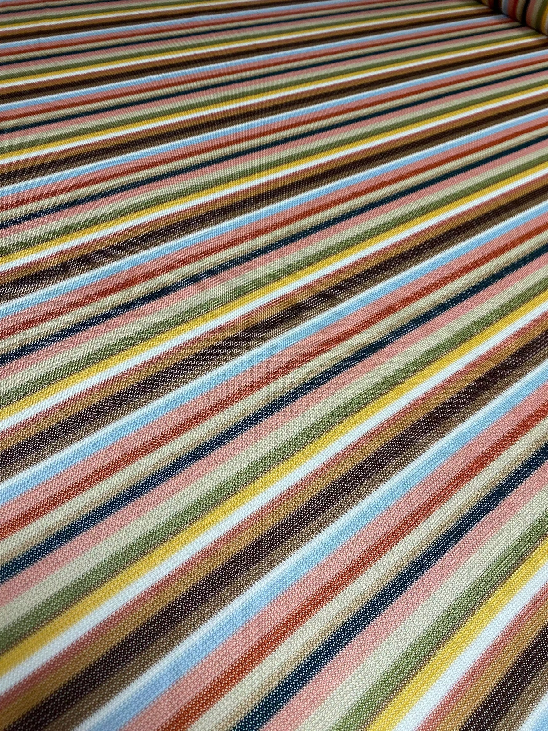 Multicolor striped woven fabric with vibrant green and pastel tones, perfect for sewing garments and creative projects