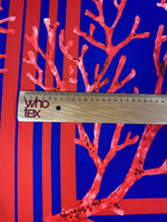 Red coral pattern fabric panel with navy blue background and ruler for scale