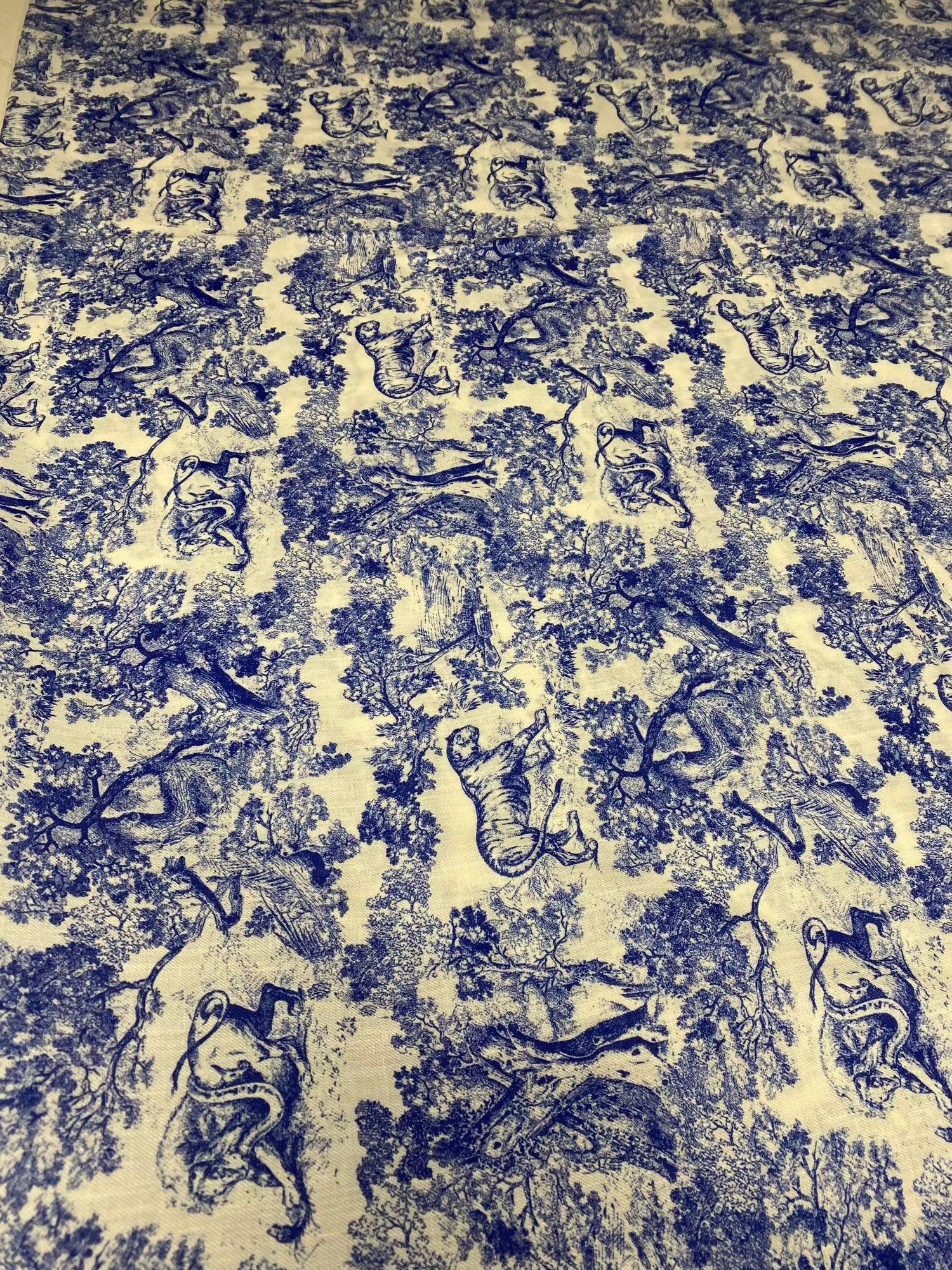 Lion design linen fabric with intricate blue lion and nature patterns on beige background for home decor and upholstery