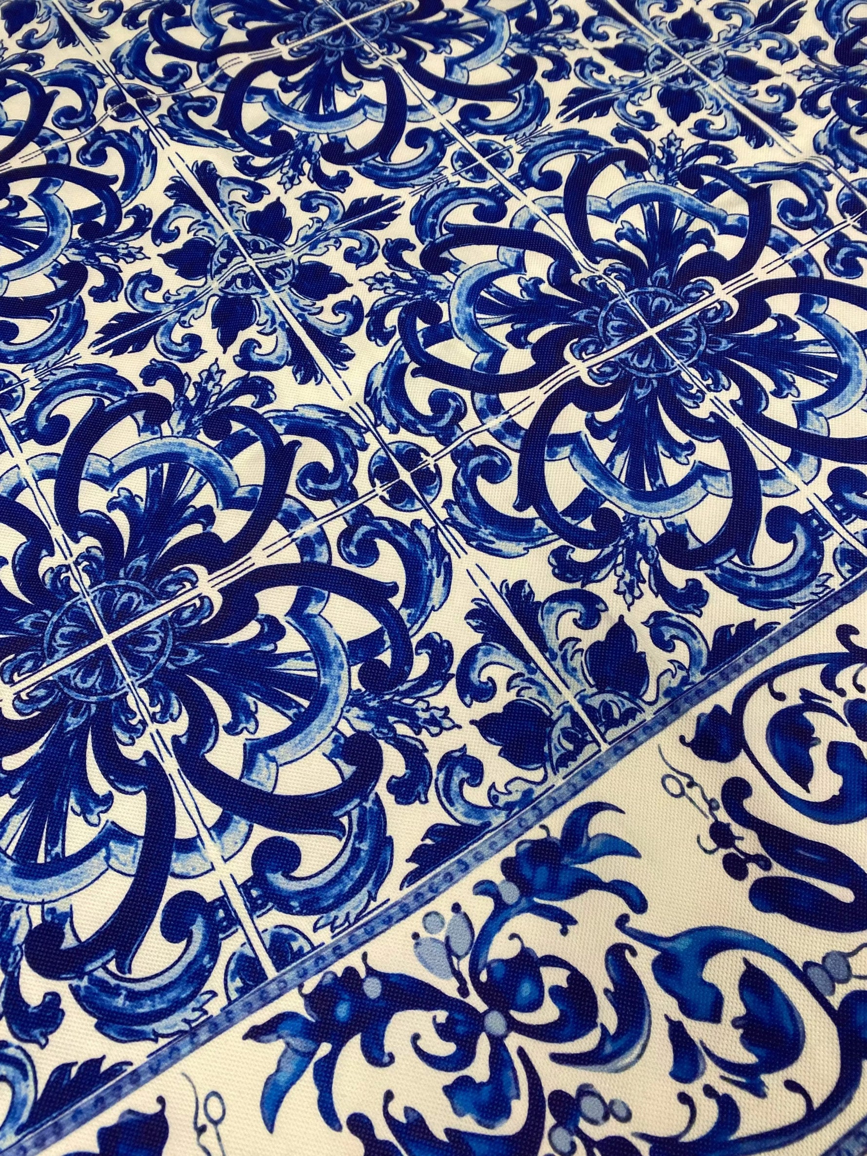 Close-up of blue and white floral patterned upholstery fabric with intricate Mavi design and decorative motifs