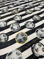 artistic portrait upholstery fabric with black and white striped background and various vintage-style faces in circles for unique home décor