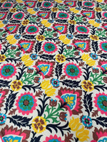 Colorful floral upholstery fabric with vibrant blossoms and intricate patterns for home décor and crafts