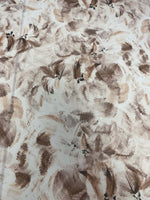 abstract brown floral fabric with soft, warm-toned flowers and leaves pattern on a light background
