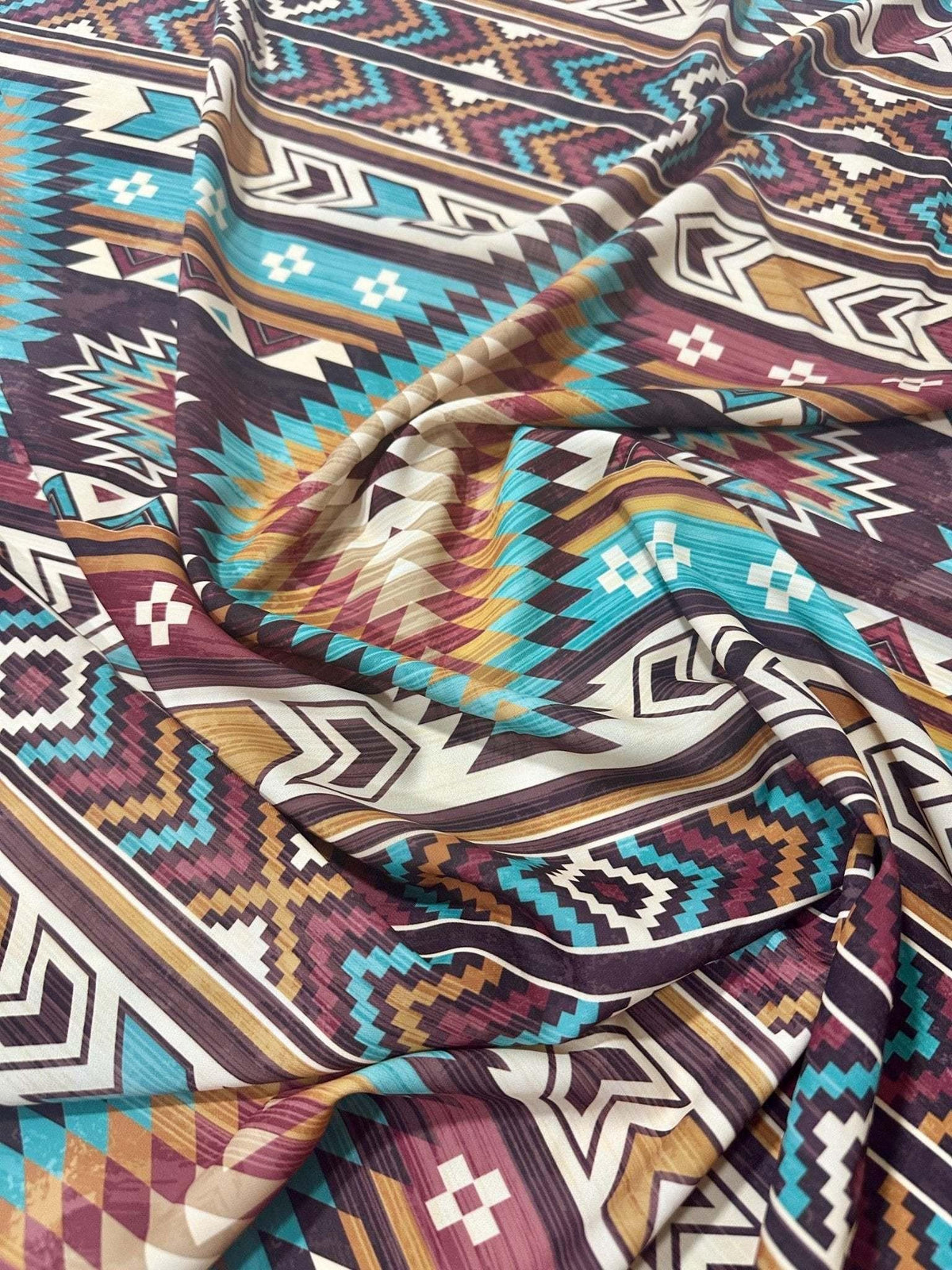 Aztec Retro Southwest Fabric with vibrant geometric patterns in turquoise, brown, maroon, and beige, ideal for sewing and crafting projects.