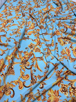 Baby blue Baroque print fabric with gold ornate floral and grapevine design, soft texture, 150cm width, ideal for sewing and home decor projects