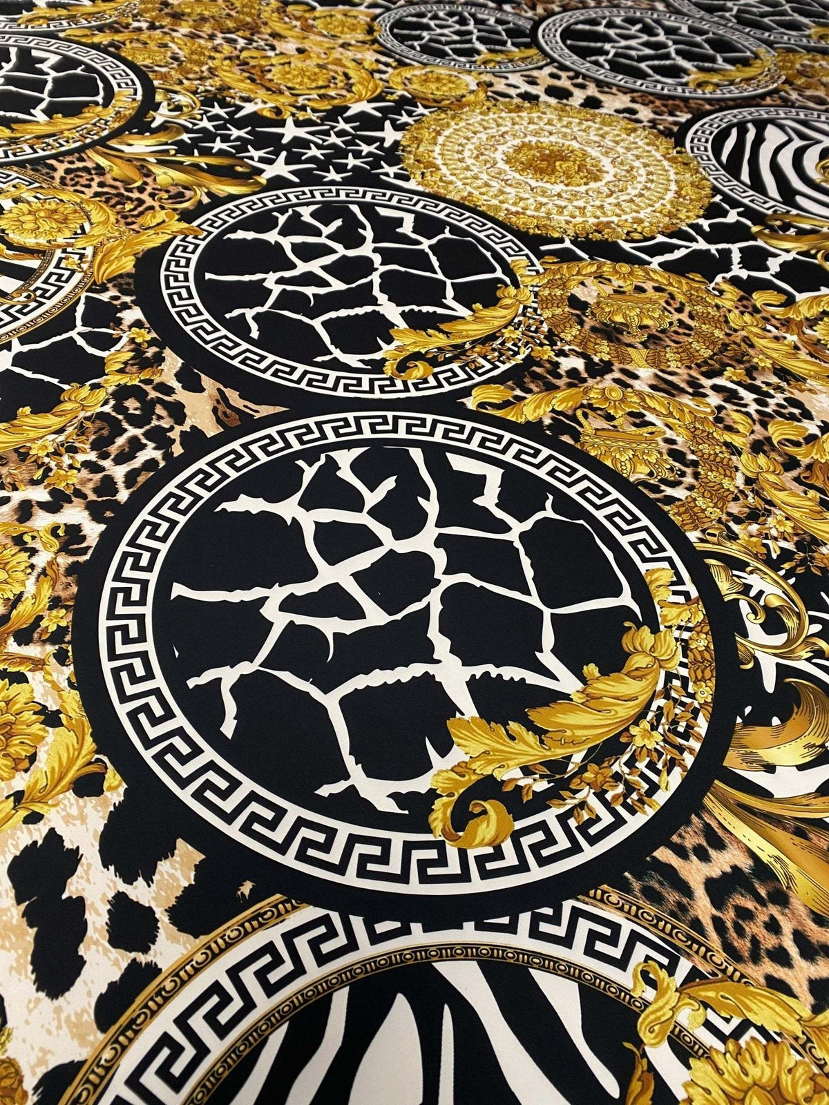 Baroque Greek Key Fabric with black, gold, and animal print patterns featuring elegant Greek key motifs and baroque designs