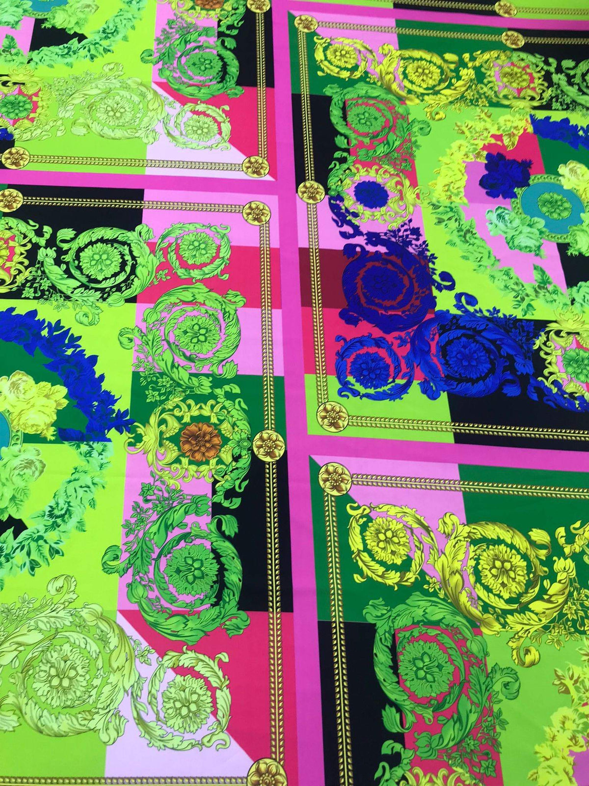 Green and pink Baroque pattern fabric with intricate ornamental design for decorative projects