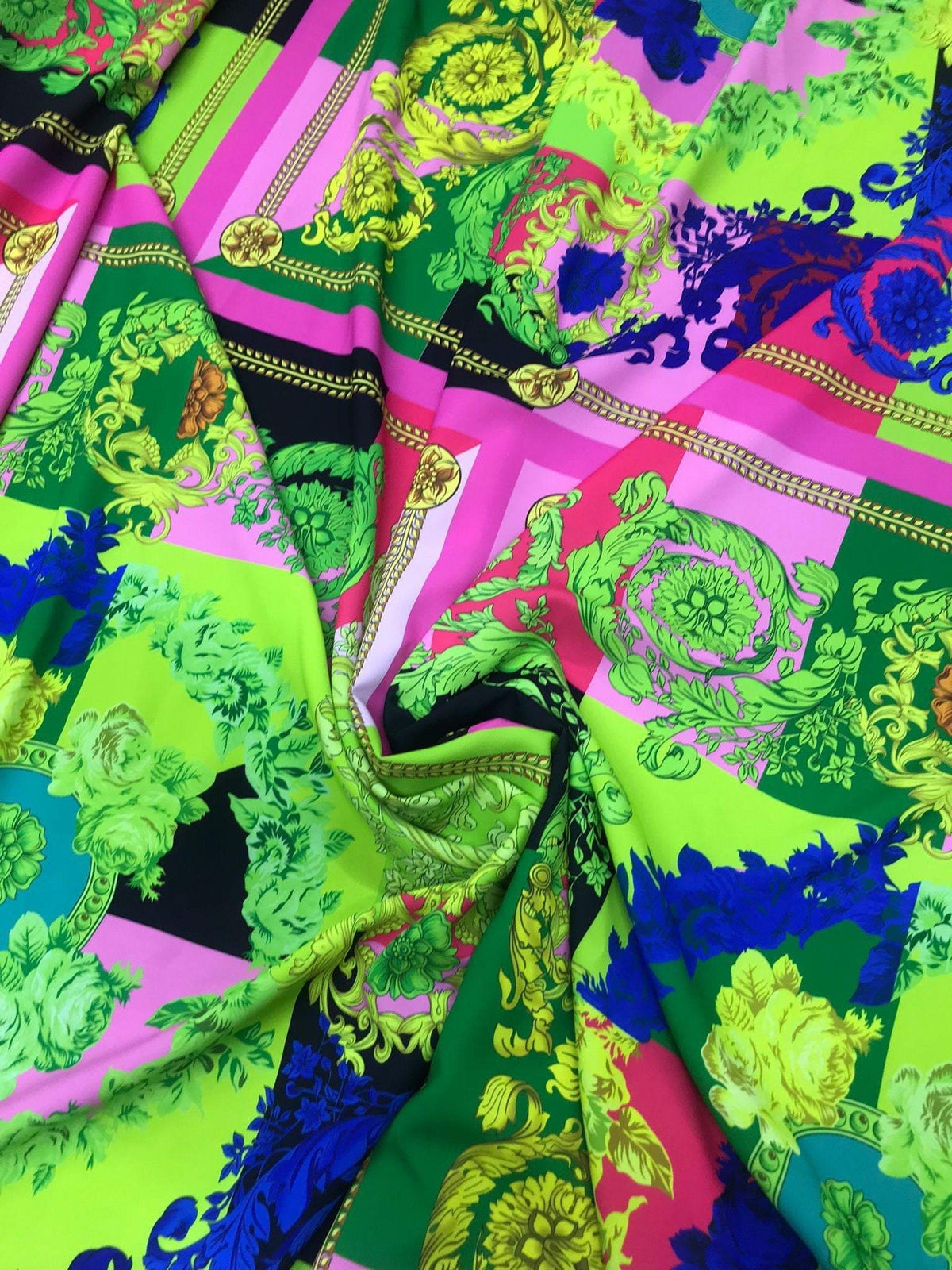Green and pink Baroque pattern fabric with intricate decorative designs for upholstery and curtains