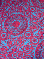 Blue fabric with intricate red baroque pattern design for upholstery and sewing projects