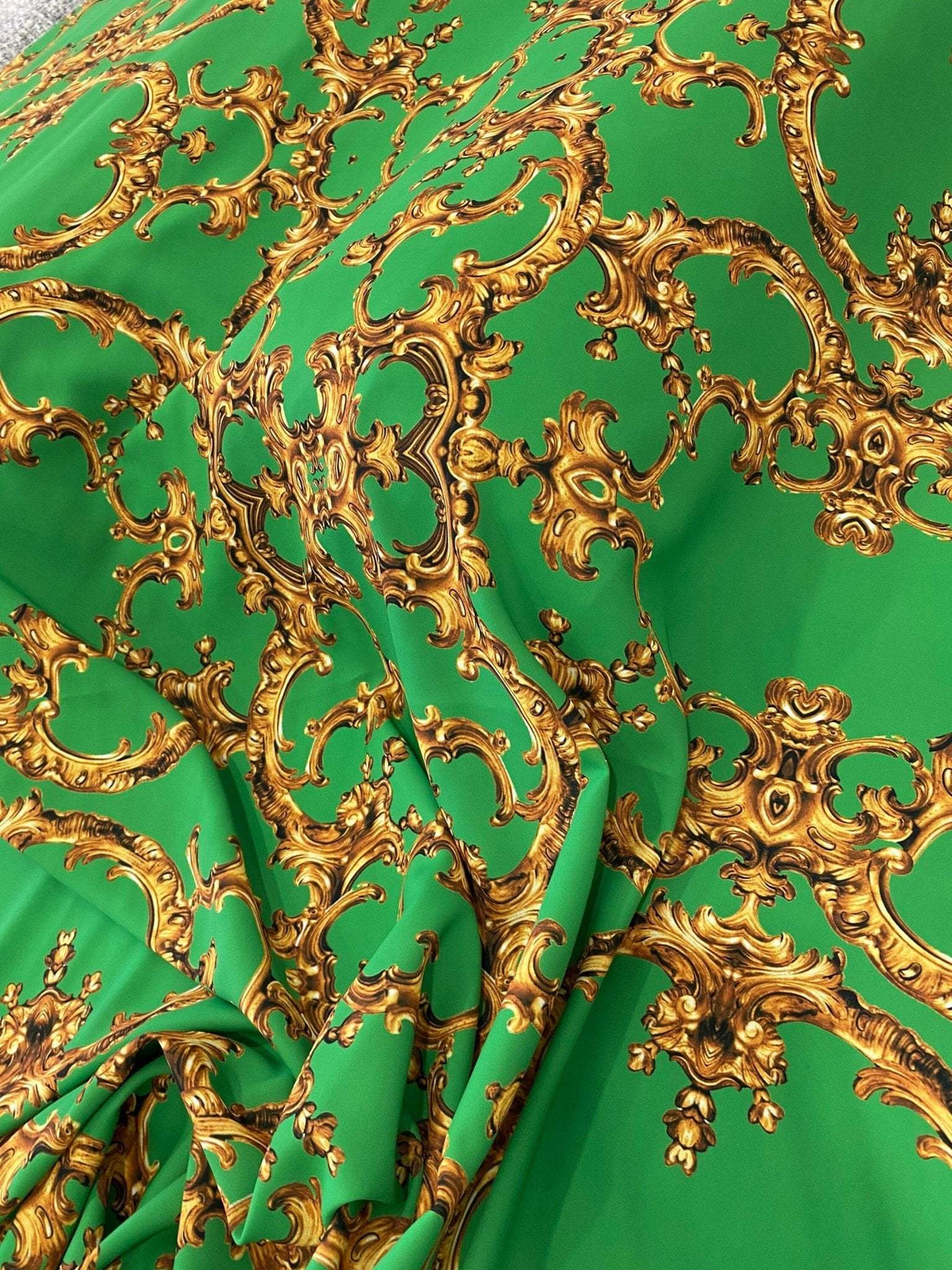 Baroque green gold print fabric with ornate baroque patterns on green upholstery material