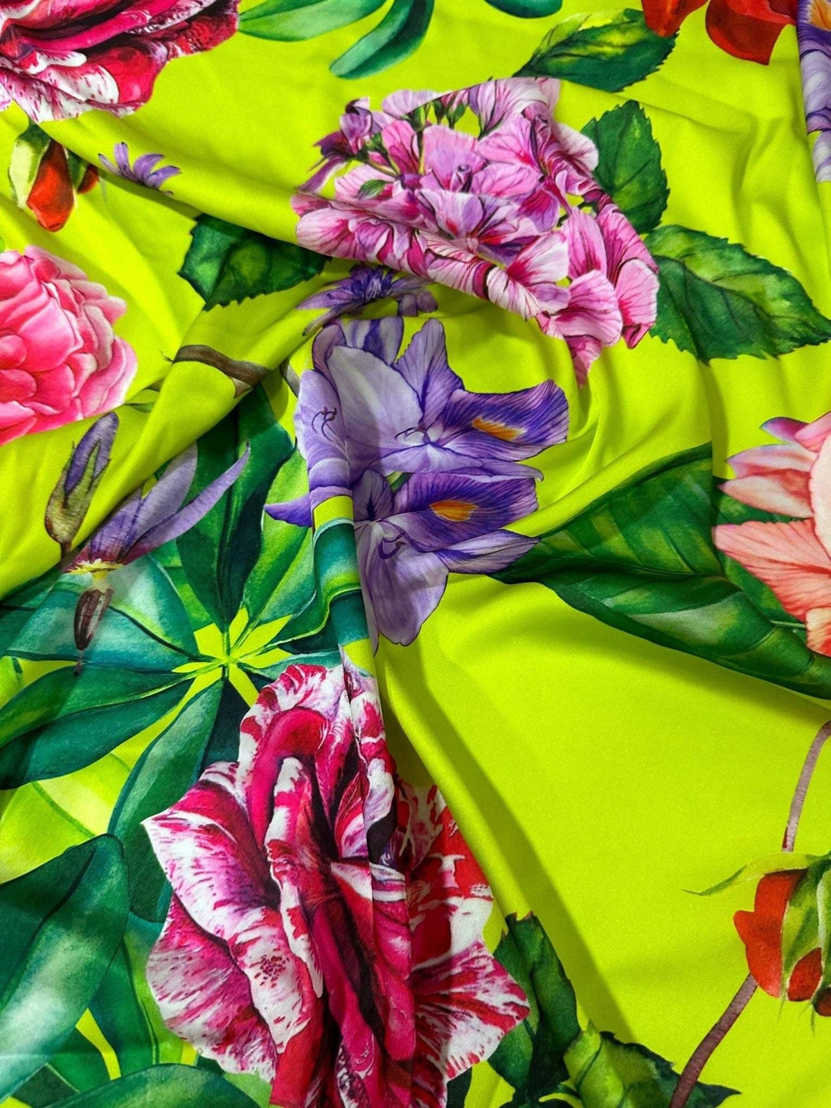 Floral neon green fabric with large vibrant rose and flower patterns on bright green background