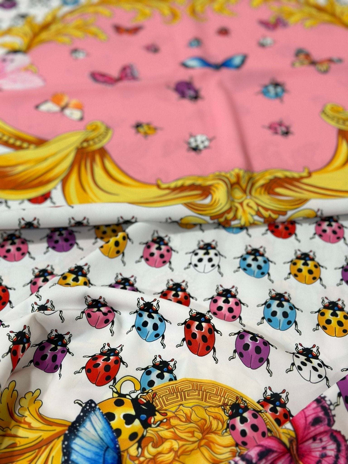 Colorful butterfly and polka dot print fabric with vibrant ladybugs and decorative ornate patterns