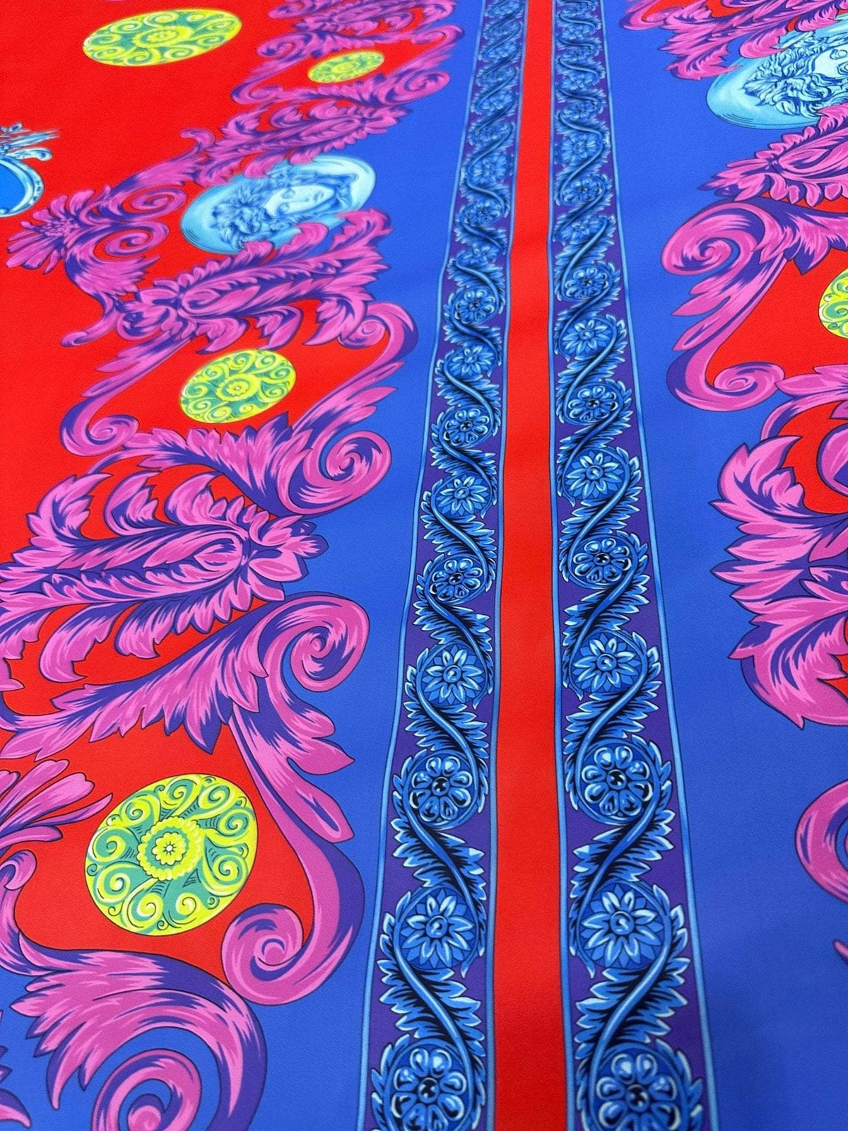 Purple swirl crepe fabric with vibrant red and blue background and intricate floral patterns
