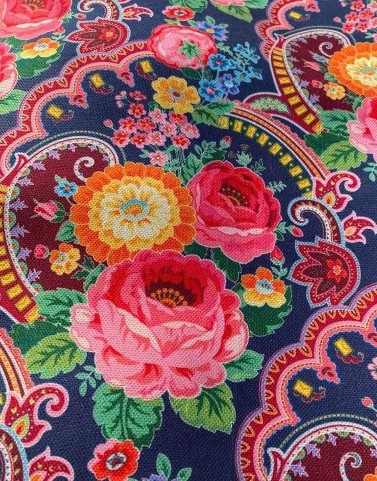 Ethnic patterned fabric with vibrant floral and paisley design on navy background for upholstery and outdoor use