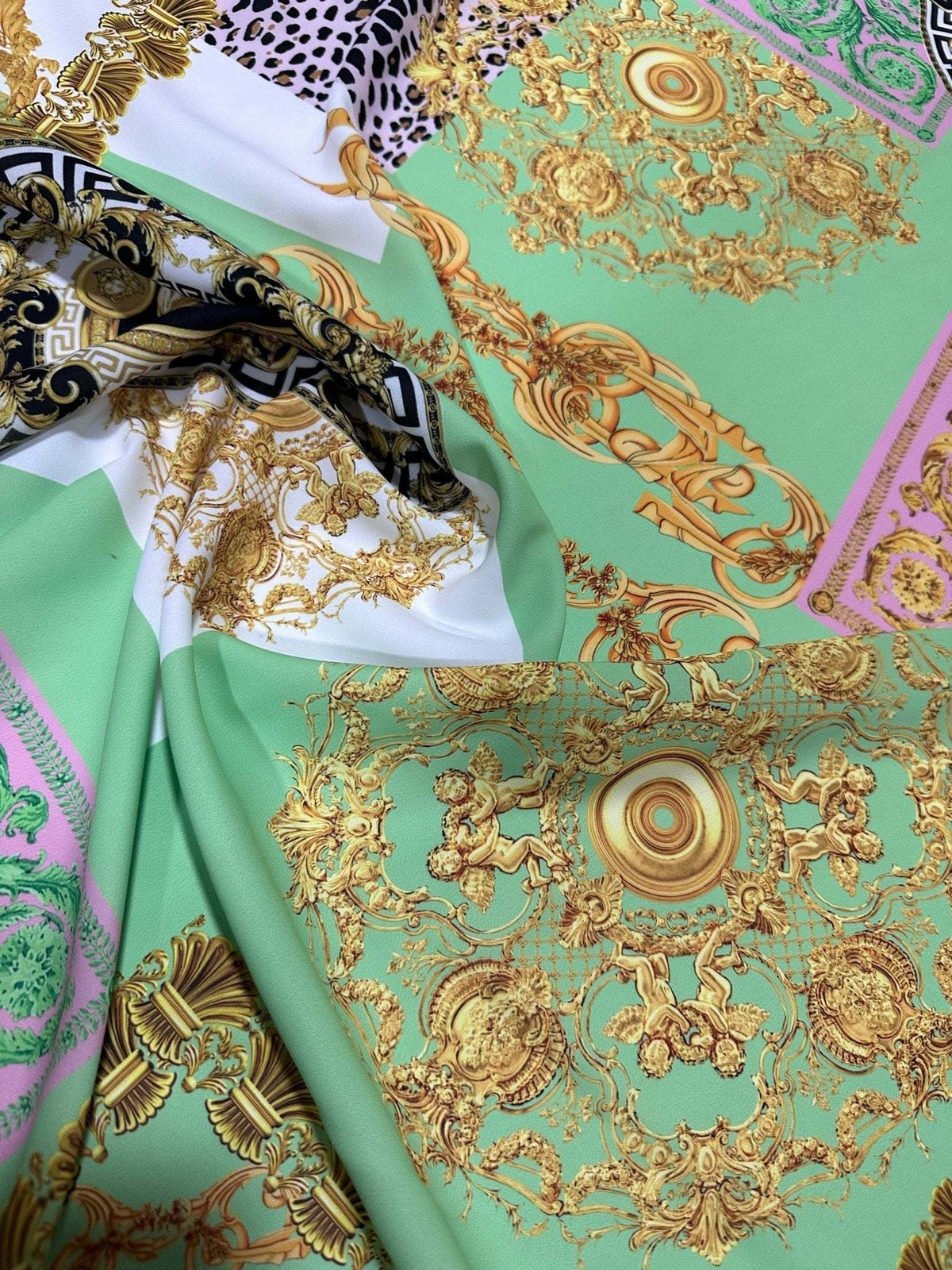 Green Baroque Crepe Fabric with elegant gold floral baroque patterns on a green background, perfect for stylish sewing projects