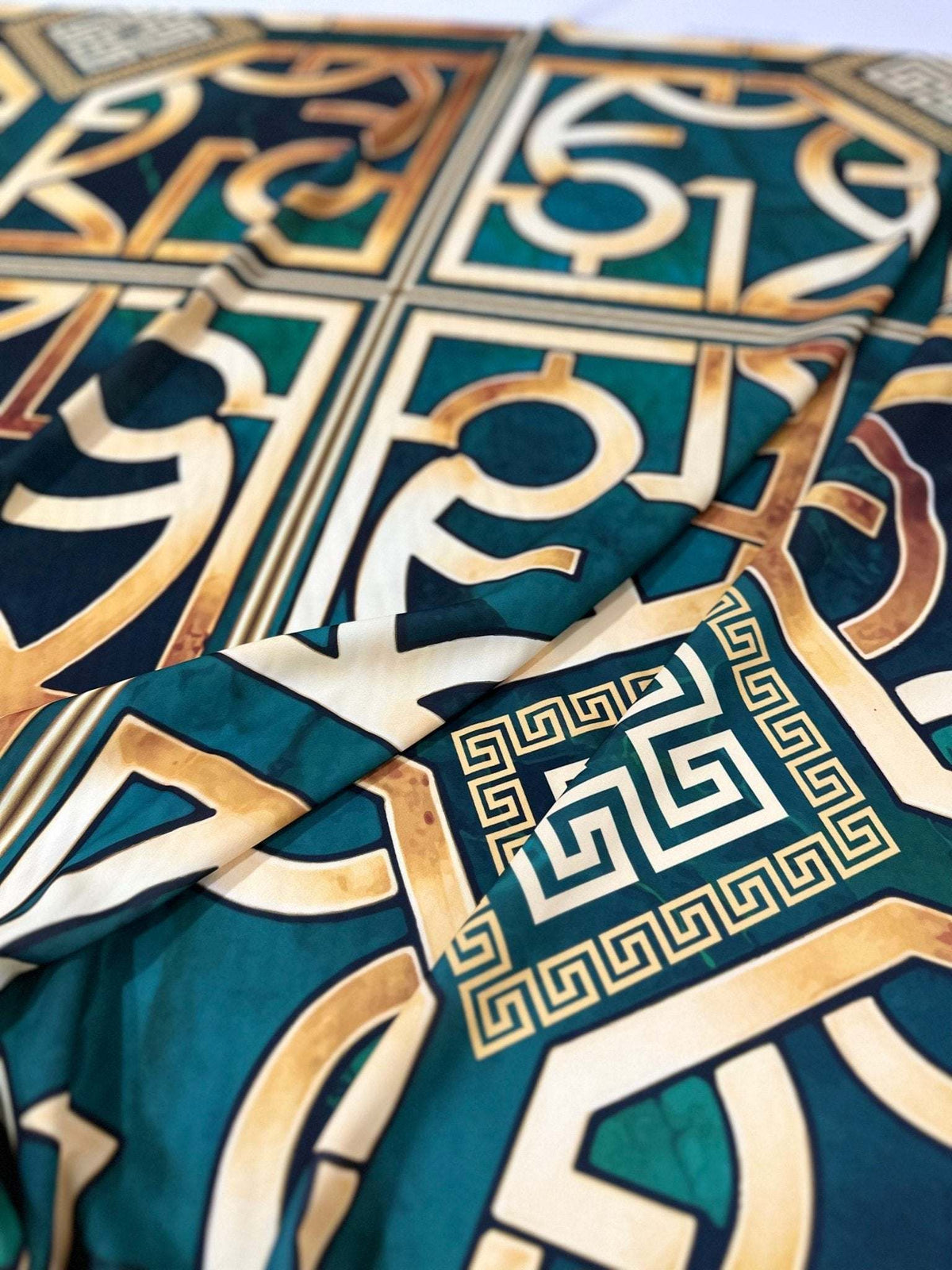 Green Gold Crepe silky fabric with Greek Key pattern and smooth texture