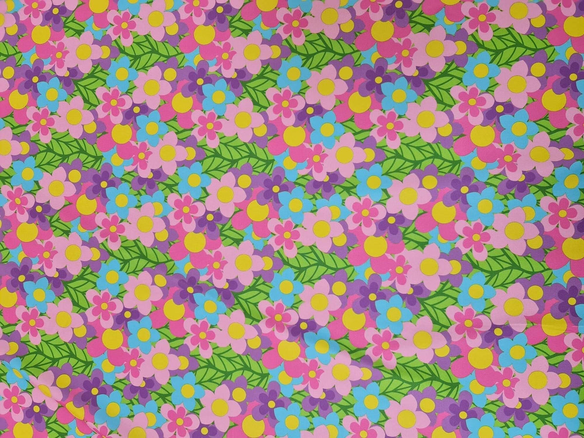 vibrant colorful floral fabric with pink, purple, blue flowers and green leaves pattern