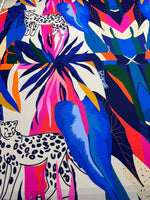 Leopard and tropical patterned fabric with vibrant blue, pink, orange, and green leaves and leopard illustrations, 150cm width