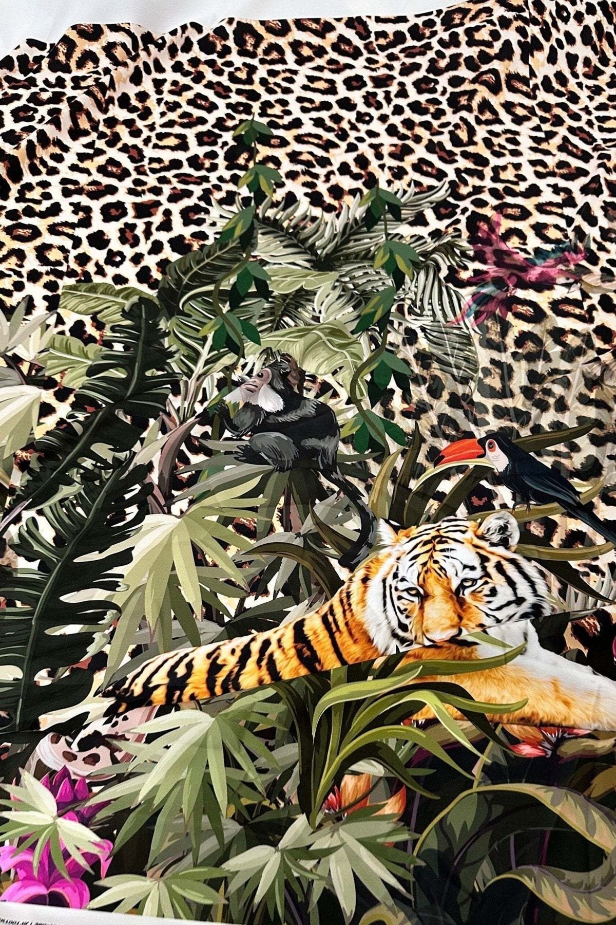 Leopard tropical leaf pattern fabric with jungle foliage and tiger print design