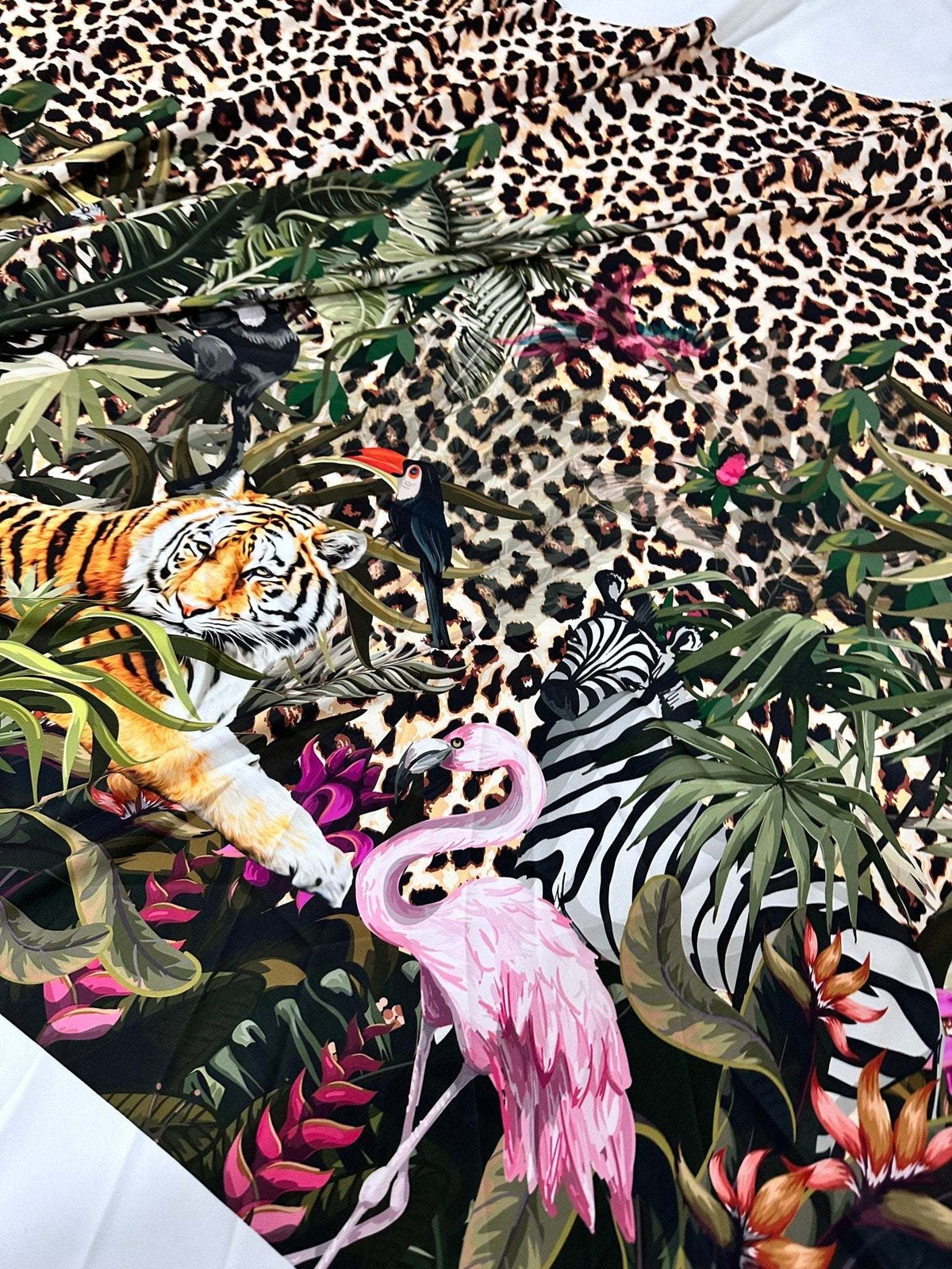 Leopard tropical leaf pattern fabric featuring jungle animals and vibrant foliage design
