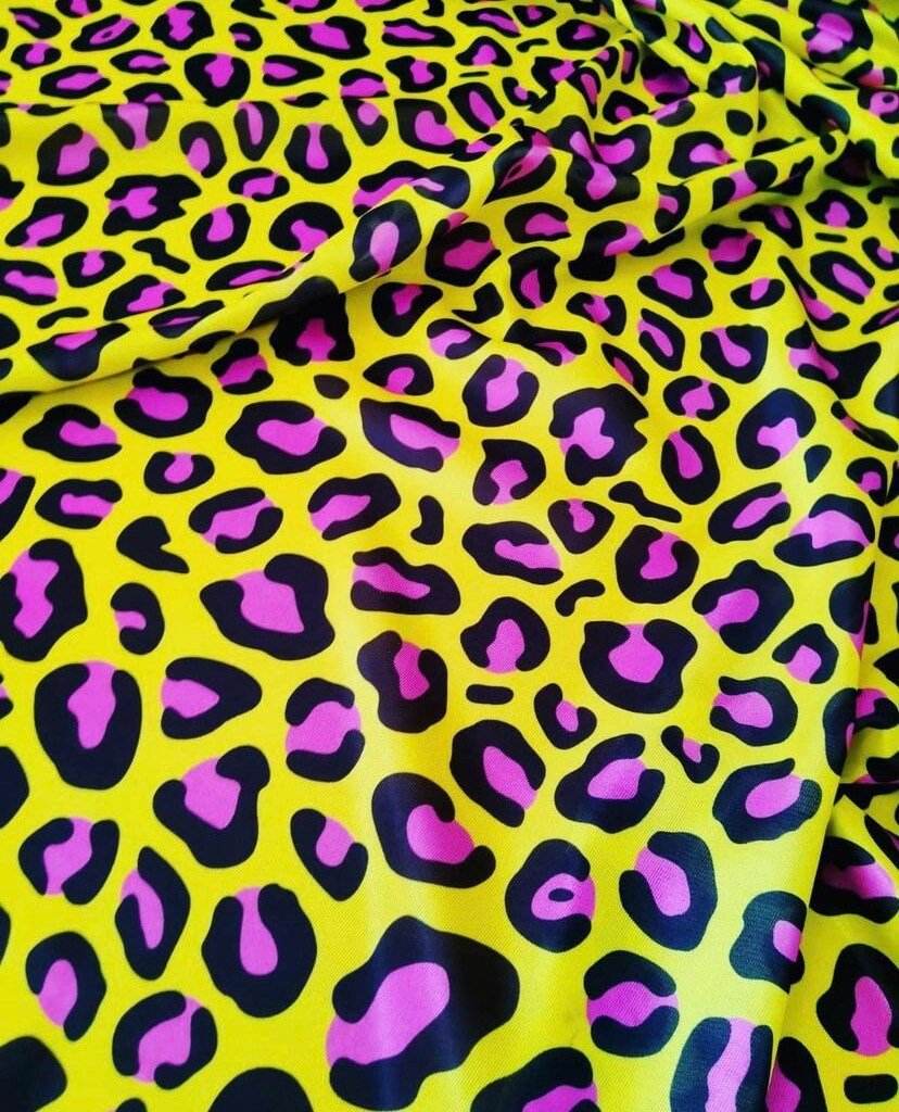 Bright yellow leopard print fabric with bold black and pink animal patterns, ideal for fashion and decor projects.
