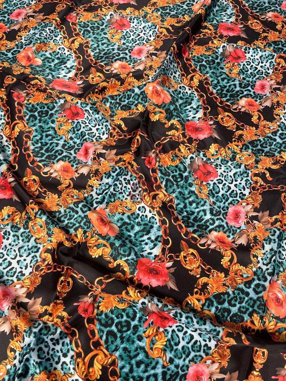 Leopard print fabric with gold chain motifs and vibrant floral accents in teal and black background