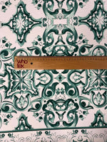 Green and white Majolica pattern fabric with intricate swirl design and ruler for scale