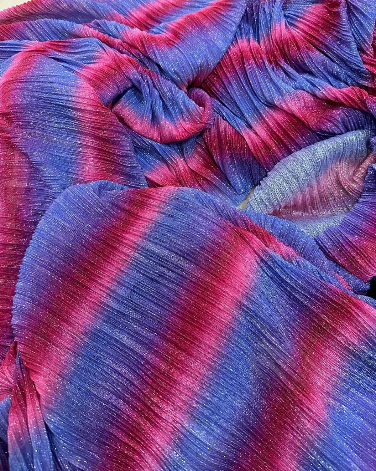 Pleated power mesh fabric with shiny threads in blue and pink gradient colors, lightweight and soft texture
