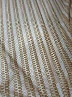 Close-up of Shimmer Zigzag Knit Jersey fabric in beige and cream chevron pattern with a soft, shimmering texture.