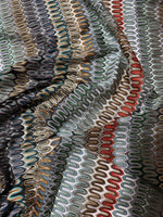close-up of colorful mesh zigzag knit jersey fabric with textured pattern and waves