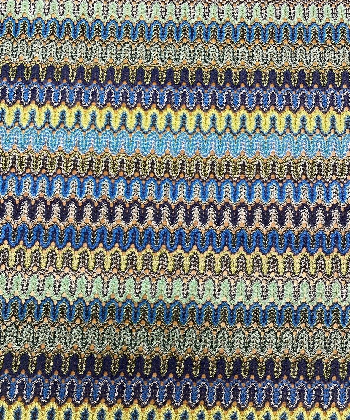 Zigzag pattern mesh fabric in yellow and blue with a wavy textured design for crafting and fashion projects