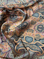 Black and orange paisley patterned fabric with intricate decorative design and 150cm width