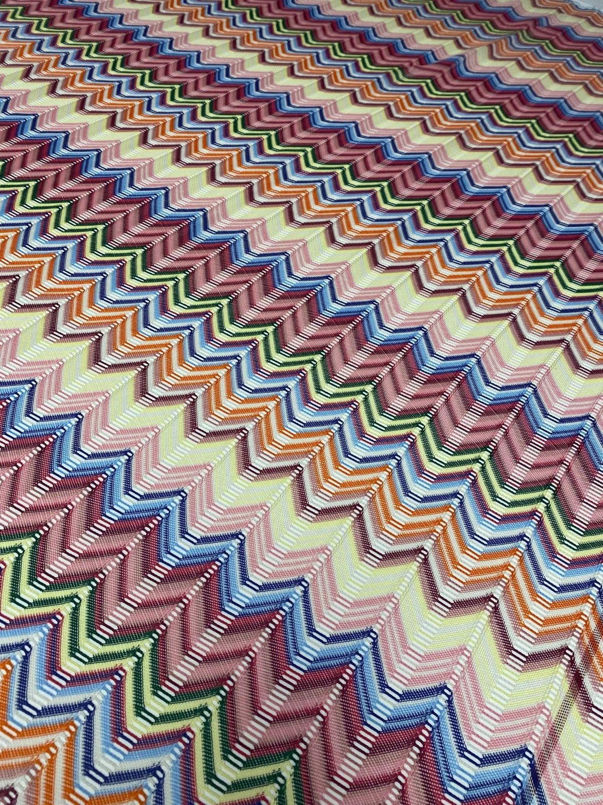 Pastel multicolor chevron mesh fabric with zigzag knit pattern in green, pink, blue, and orange tones, ideal for garments and crafts