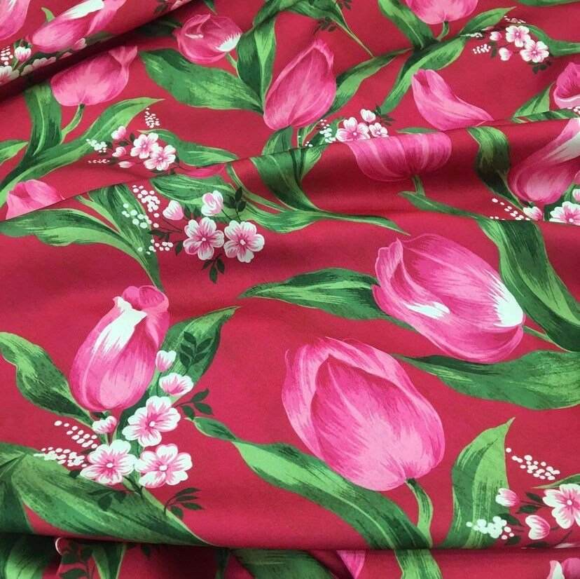 Pink Tulip Fabric with vibrant red background and pink tulip floral pattern for sewing and crafting projects