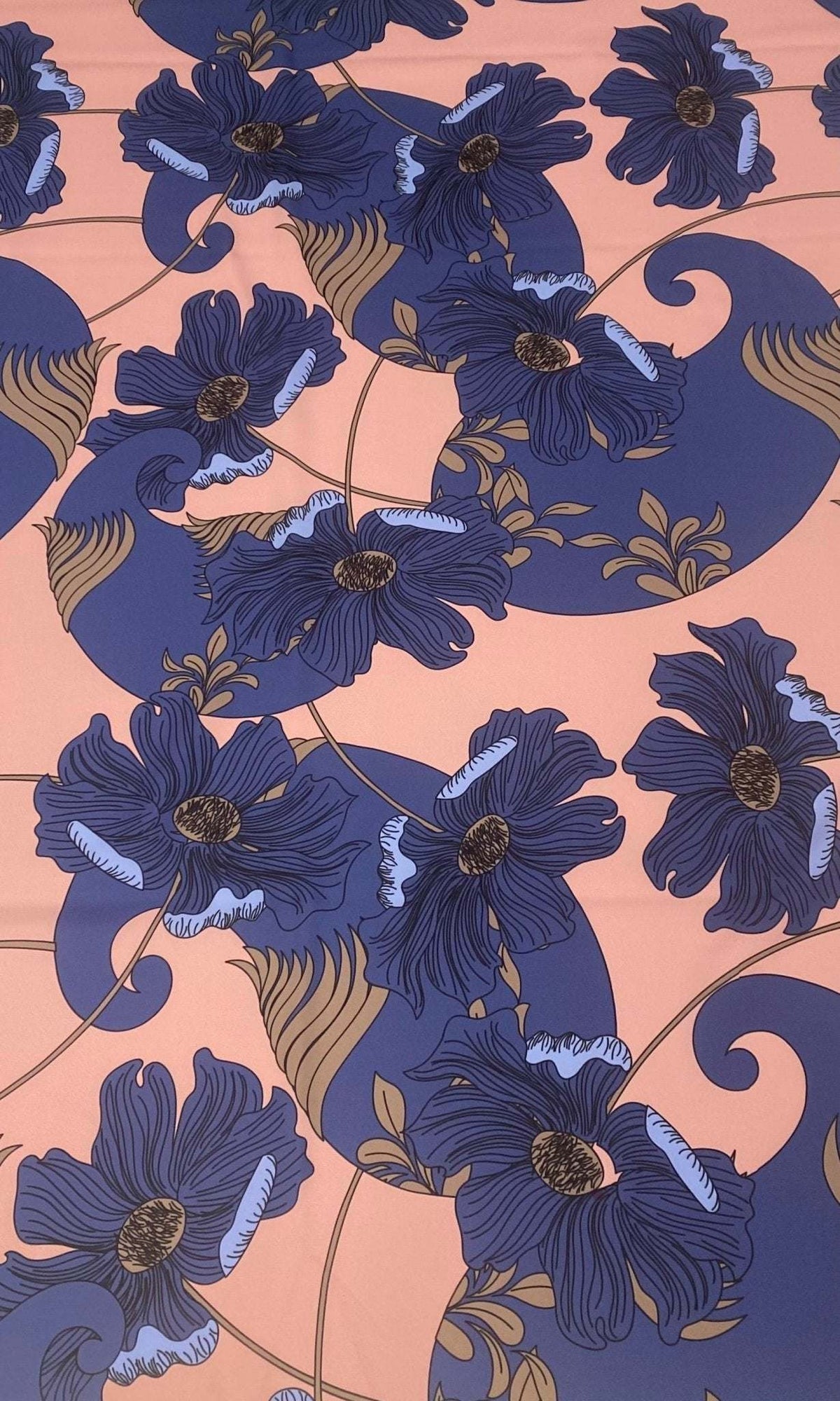 Retro style blue floral print fabric on peach background with vintage design elements