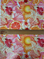 close-up of tropical citrus sequin fabric with vibrant orange, pink, and red starfish and floral patterns, showcasing 2-way stretch and sequin details