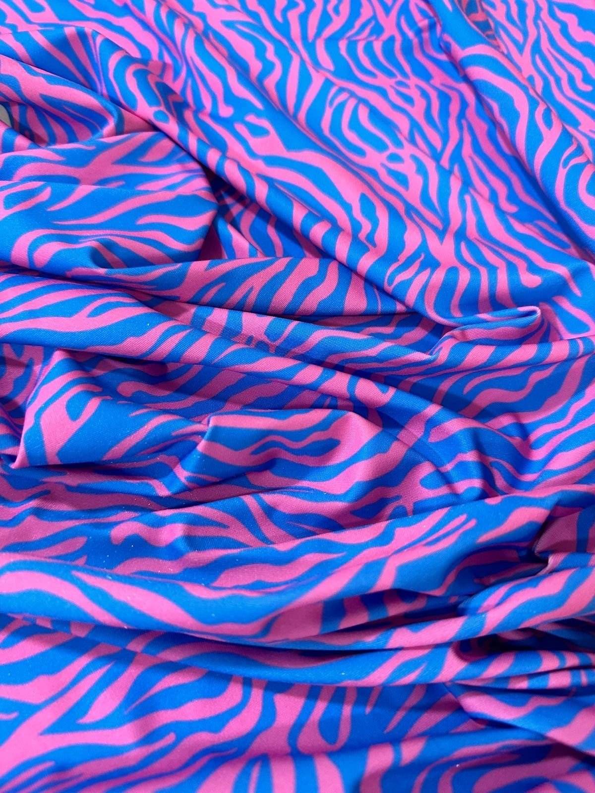Blue and pink zebra pattern fabric with vibrant animal print, 150cm wide, ideal for fashion and crafts