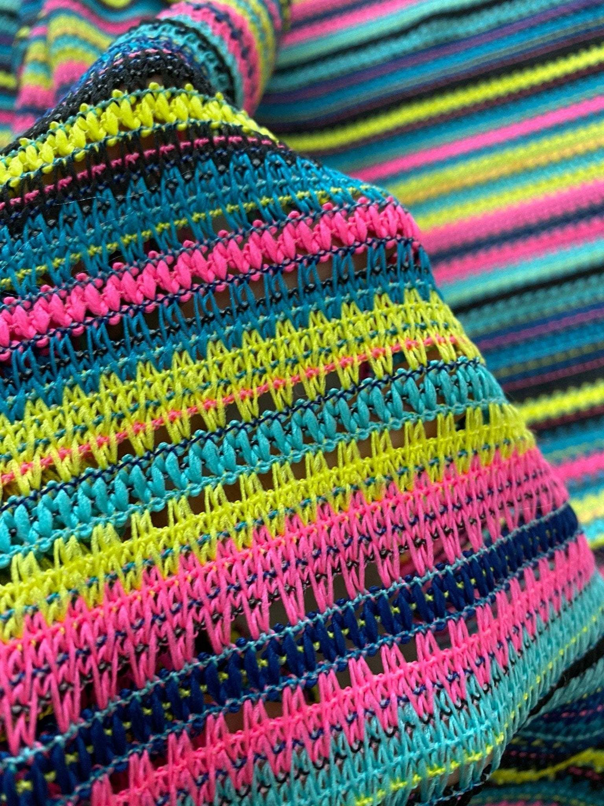 colorful zigzag knit jersey fabric with textured stripes in pink, yellow, blue, and black