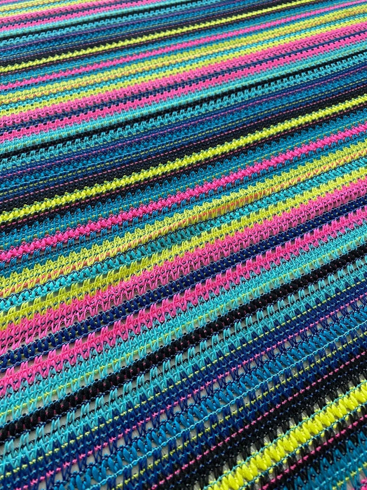 colorful zigzag knit jersey fabric with vibrant stripes of blue, pink, yellow, and black