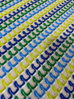 Luxury zigzag knit jersey fabric with blue, yellow, and green chevron pattern in soft textured knit